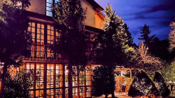 A building with large windows and a paved entrance area. - Park Hotel Amfora (Sofia)