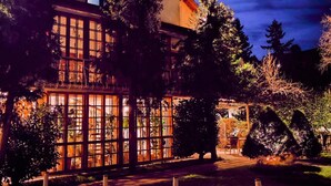 A building with large windows and a paved entrance area. - Park Hotel Amfora (Sofia)