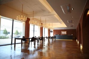 A spacious hotel lobby with a long reception desk, multiple seating areas, and large windows allowing natural light. - STAY THE GONGDAN HOTEL (Gumi)