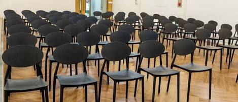 A room with rows of chairs arranged for an event.