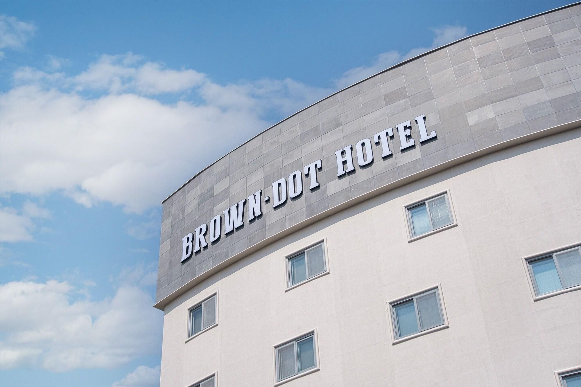 A building with the sign 'BROWN-DOT HOTEL' on the facade.