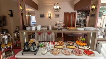 A breakfast buffet with various food items and a coffee station.
