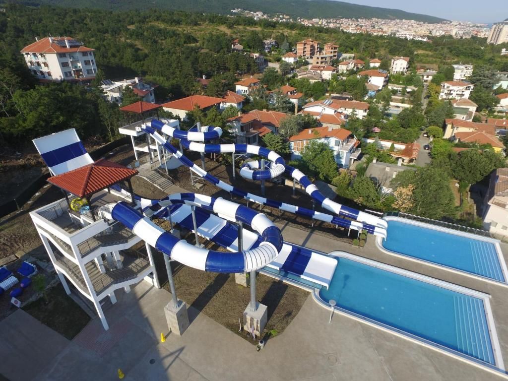 A water park with multiple slides and a pool.