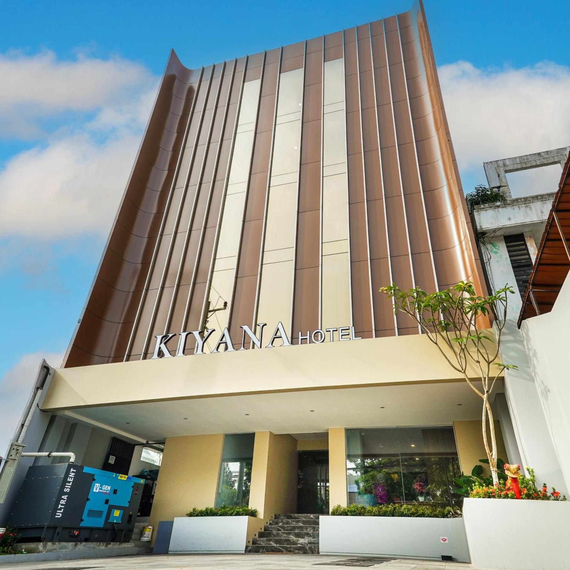A modern hotel building with a prominent sign reading 'KIYANA HOTEL'.