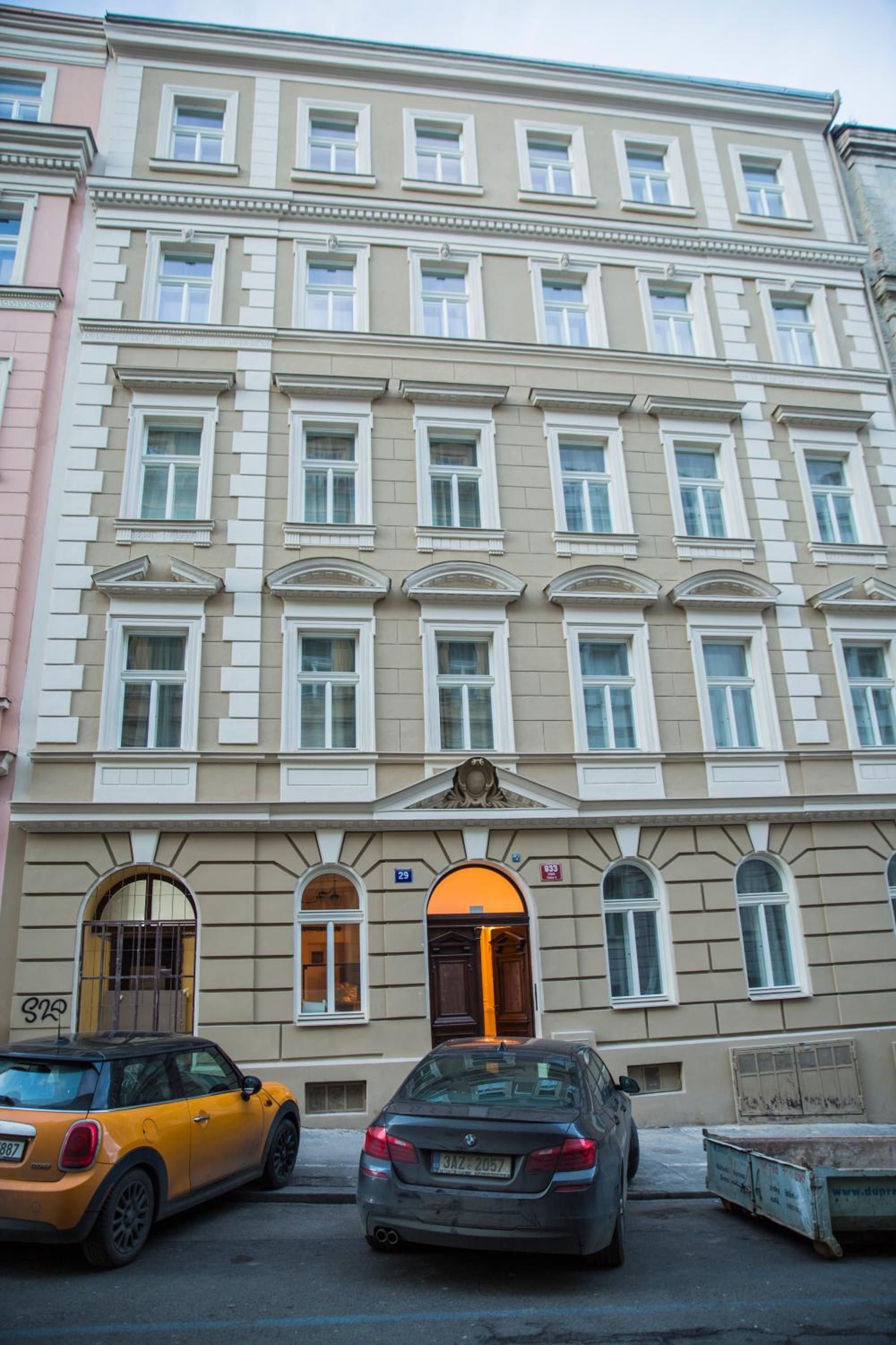 A multi-story building with a classic architectural style, featuring a central entrance with a decorative archway and a set of double doors.