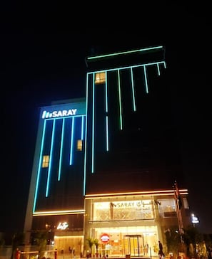 A hotel with a prominent 'SARAY' sign, a modern facade, and a well-lit entrance. - Saray Deluxe Hotel Apartments (Abu Dhabi)