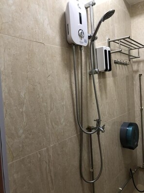 A bathroom with a wall-mounted shower unit, a towel rack, and a hand dryer. - Capsulepod@aljunied (Singapore)