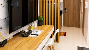 A modern kitchen with a marble backsplash, wooden counter, and a large flat-screen TV. - Luxury Stay for Less • Cozy Vibes + Epic Sunsets (Pasay City)