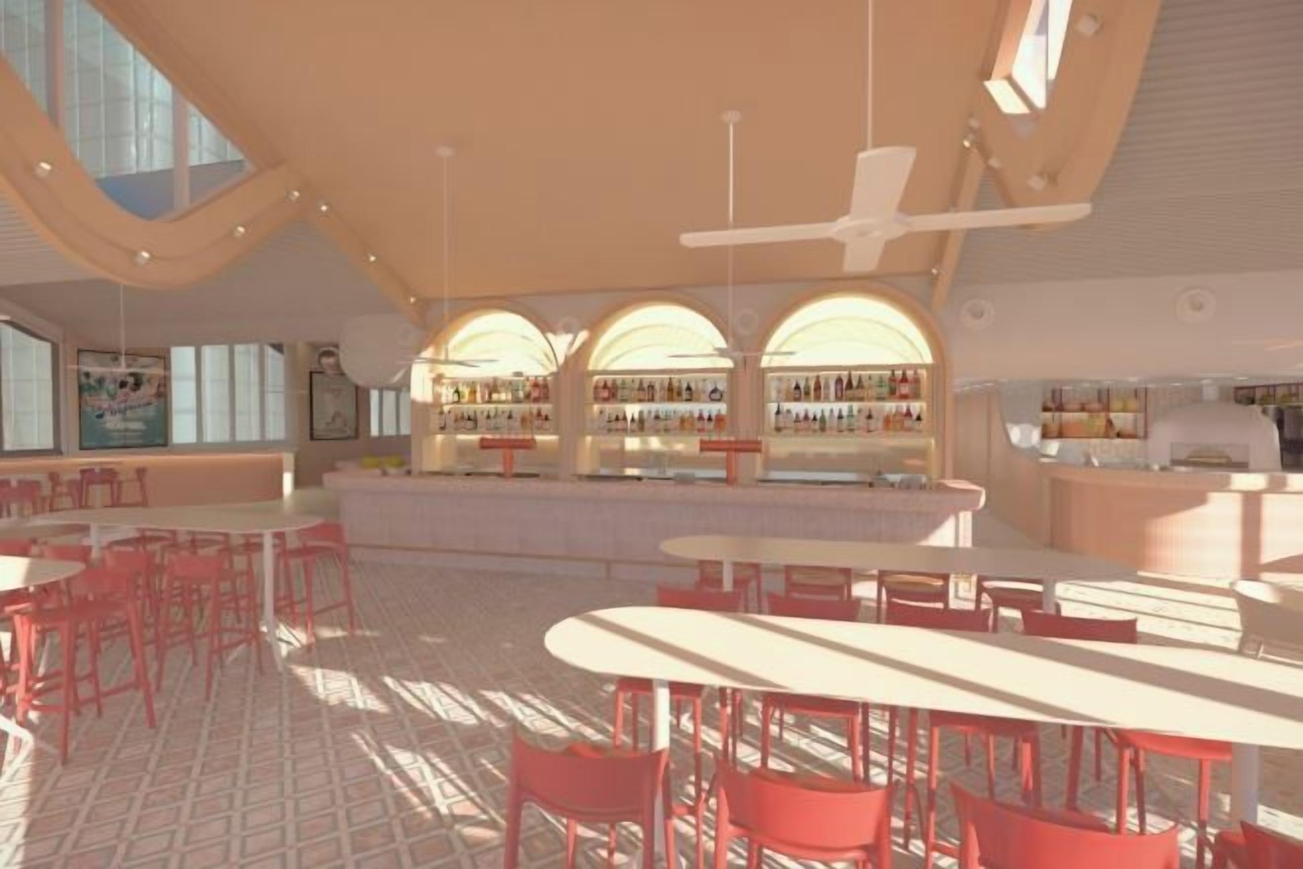 A spacious indoor area with tables and chairs, a bar area with shelves of bottles, and a large window allowing natural light.