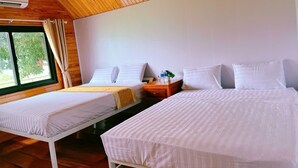 A room with two beds, wooden ceiling, and a window with curtains. - Retreat Bungalow (Phong Nha)