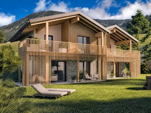 Ein modernes, zweistöckiges Haus mit Balkon, Pool und Bergblick.
