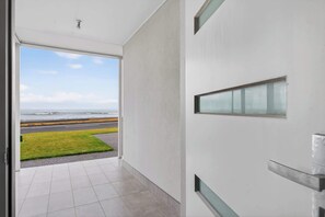 A modern interior with a view of the ocean through a large window. - 35A Franklin Pde Encounter Bay (Encounter Bay)