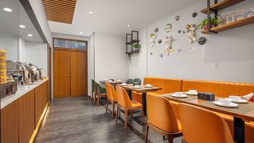 A restaurant with wooden furniture, a buffet area, and wall decorations.