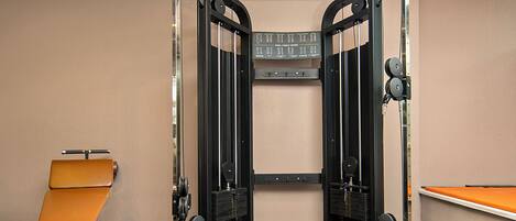 A gym with a pull-up bar, weight bench, and exercise equipment.