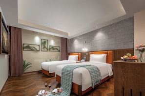 A hotel room with two beds, a wooden headboard, a nightstand with a fruit bowl, and a wall-mounted TV. - Borrman International Hotel Shunyi (Shunyi)