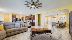 A spacious living area with a sofa, coffee table, and dining table. - Alamo Heights Haven+15 min 2 Seaworld+Pet Friendly (San Antonio)
