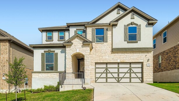 A two-story house with a stone facade, a garage, and a small front yard. - Alamo Heights Haven+15 min 2 Seaworld+Pet Friendly (San Antonio)