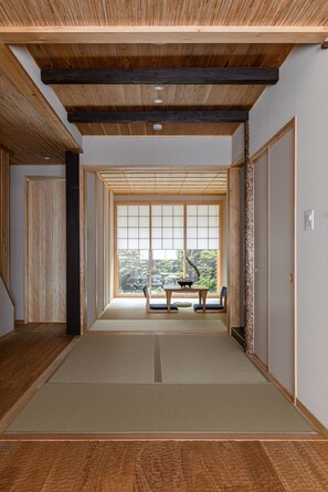 A traditional Japanese room with tatami flooring, a sliding door, and a view through a shoji screen. - Kyoran [6 min. by cab from Kyoto Stn.] Max. 6 people｜Renovation in 2025｜Private use of a machiya in a quiet alleyway｜Nishi Honganji temple nearby (京都市)
