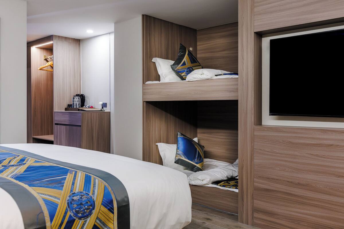 Premium bedding, desk, laptop workspace, blackout drapes