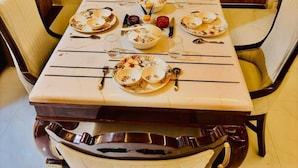 A dining table set with plates, glasses, and cutlery.