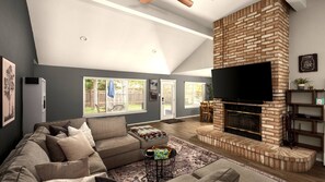 A living room with a fireplace, a sofa, a coffee table, and a TV mounted on the wall. - Luxe 3BR 2BA Shady Hollow Stay | King Bed + Office (Austin)