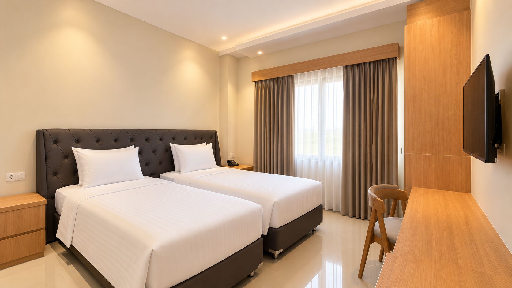 A hotel room with two beds, a desk, a chair, a TV, and a window with curtains.