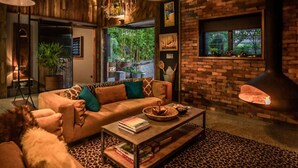 A cozy living room with a sofa, coffee table, and fireplace.
