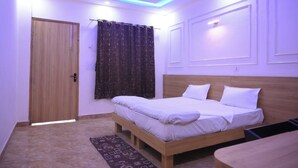 Une chambre avec un lit en bois, un ventilateur de plafond et un tapis à motifs.