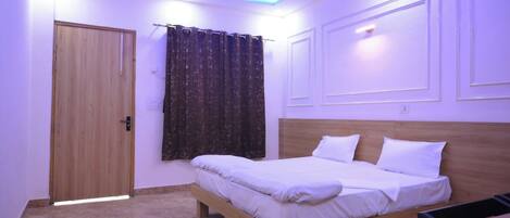 A bedroom with a wooden bed, a ceiling fan, and a patterned rug.