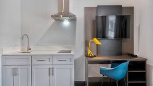 A modern kitchen with a built-in stove, a sink, and cabinets. - 2 Queen Beds | Suite, Non-Smoking, Kitchen (Eureka)