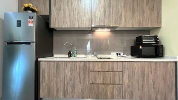 Apartment, 2 Bedrooms, City View | Private kitchen | Fridge, cleaning supplies