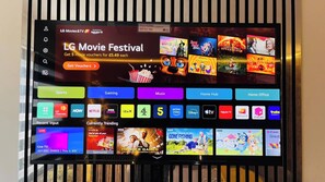 A TV screen displaying a movie festival advertisement and various streaming service icons.