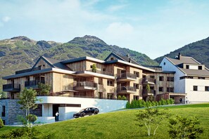 A multi-story building with balconies, a stone base, and a car on a driveway. - Modern holiday apartment with a beautiful view (Ladis)