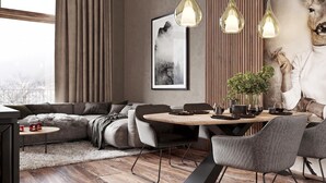 A modern living room with a sofa, dining table, chairs, pendant lights, a framed artwork, and a potted plant.