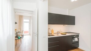 A modern kitchen with dark cabinets, a sink, and a countertop.
