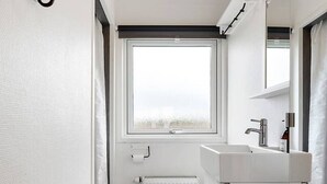 Un bagno moderno con il water, un lavandino e una finestra.