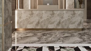 A reception desk with a marble top and a wooden panel backdrop.