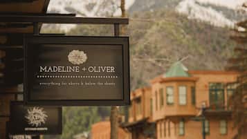 A sign with the name 'Madeline + Oliver' and a floral design, indicating a hotel or establishment.