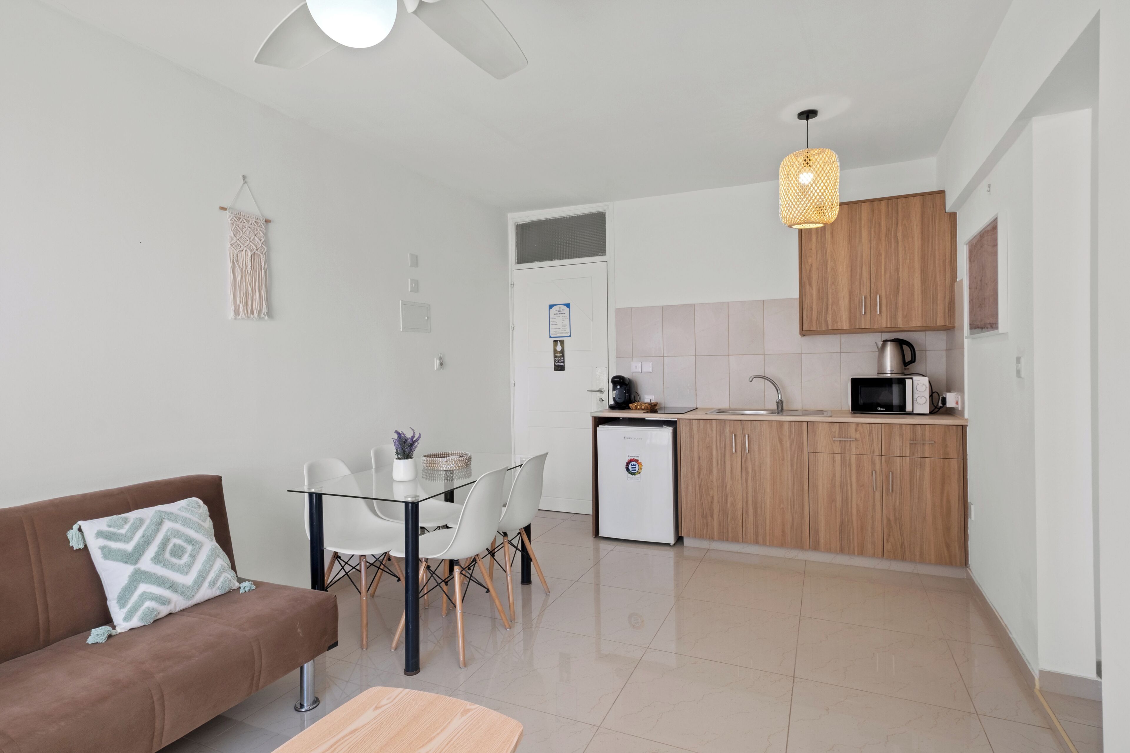A modern apartment with a kitchenette, a dining area, and a living space.