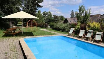 Seasonal outdoor pool, pool loungers
