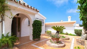 A white building with a tiled roof, an arched entrance, and a sign reading 'CASA'. - Villa La Casita Fuente del Baden 52 (Nerja)