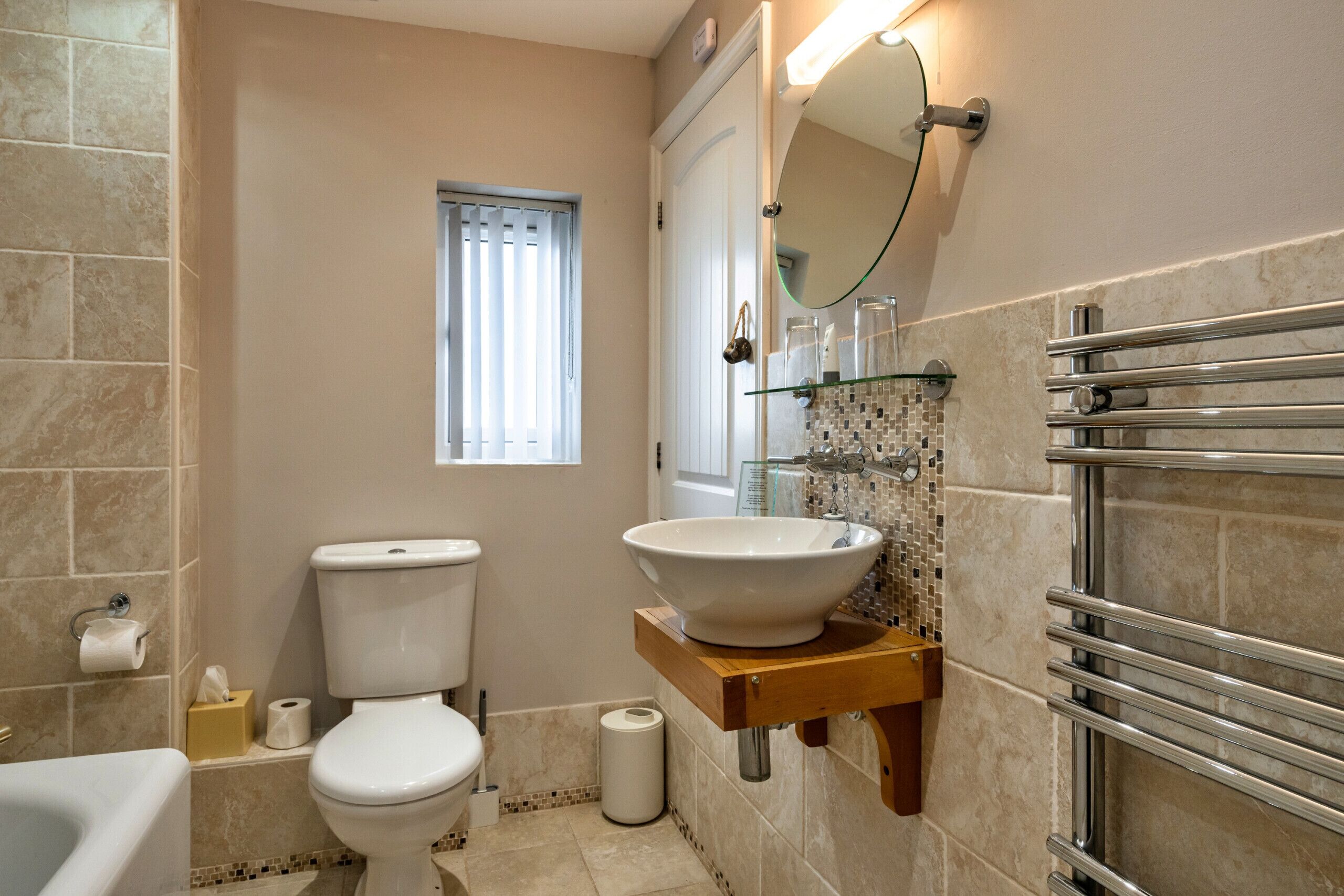 A bathroom with a toilet, sink, and shower.