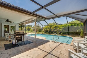 An outdoor pool area with a covered patio, a grill, and lounge chairs. - Heated Pool! Extended Stay 4 Mi to Manasota Beach (Englewood)