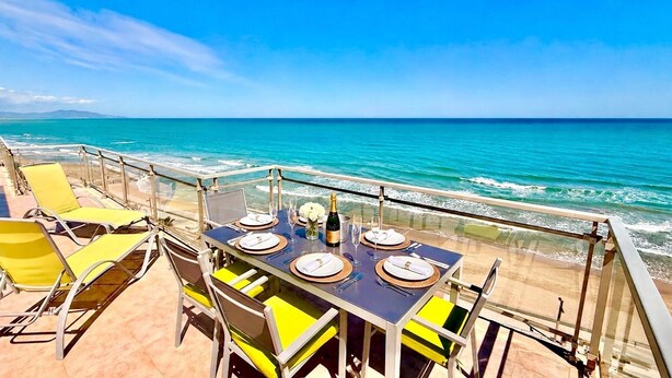 A table set for two with a view of the ocean.