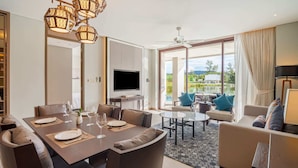 Ett modernt hotellrum med en matplats, en soffa och en TV.