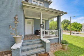 A two-story house with a porch, a mailbox, and a small garden. - Prime Charlotte Retreat 1 Mi to Uptown! (Charlotte)