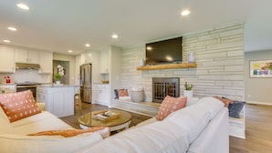 A modern kitchen with white cabinets, a built-in oven, and a stainless steel refrigerator. - Angler-Friendly Retreat Near Tennessee River (Florence)