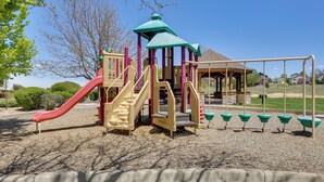 A playground with a slide, climbing area, and swings. - Easy E470 & 125 Access! Quiet Englewood Condo (Englewood)