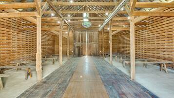 A large hall with a high ceiling, wooden beams, and a central aisle.
