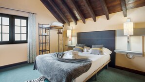 A hotel room with a bed, a window, a ladder, and a lamp. - Sunset Village A Apartment with Sea View, Wi-Fi and Air Conditioning (Sao Jorge)